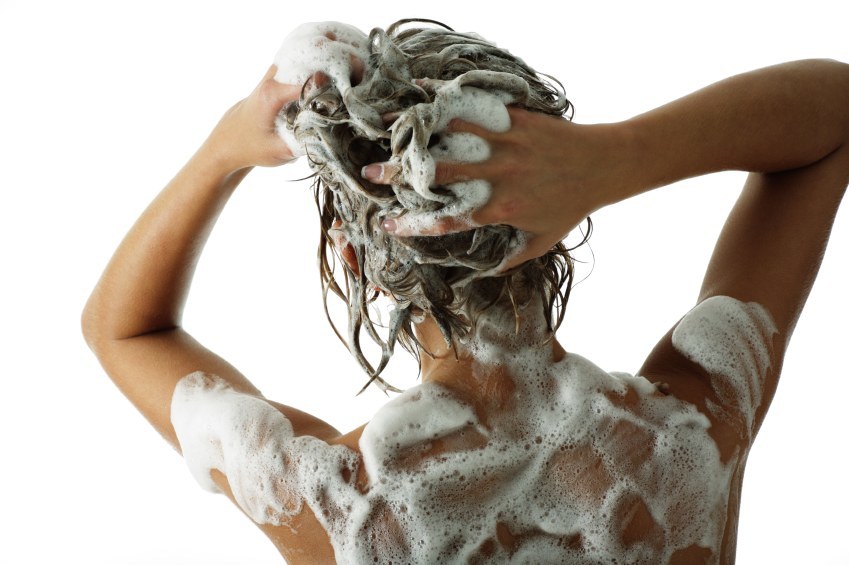 Woman lathering shampoo into her hair